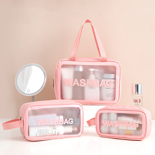 minimalist-pink-clear-makeup-pouch-organized-with-skincare-bottles-on-vanity